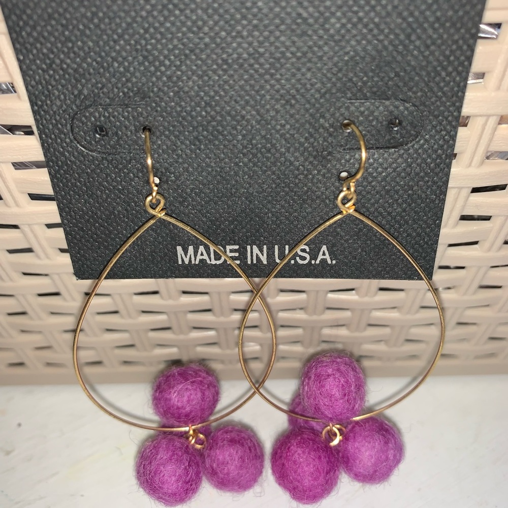 One pair Pom and goldtone 3” dangle earrings with J hooks. 4 purple poms NWT